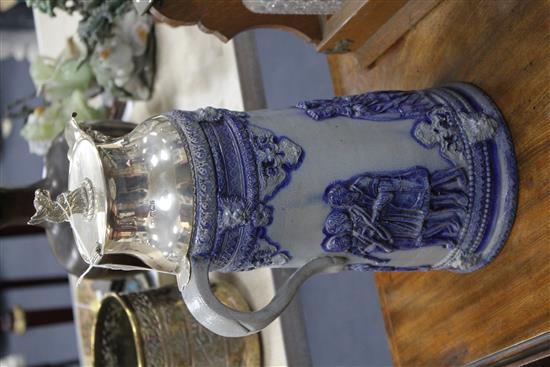 An early 20th century blue glazed German stoneware flagon, with silver plated griffon head mount, height 40cm